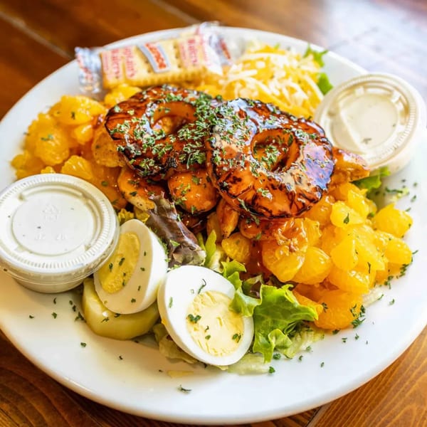 Barnes Restaurant's BBQ shrimp and pineapple salad with hard-boiled eggs, cheese, and crackers.