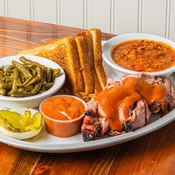 Barnes Restaurant's BBQ plate with brisket, green beans, baked beans, Texas toast, and pickles.