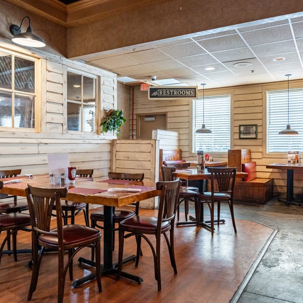 Interior of Barnes Restaurant, a BBQ eatery, with wooden tables, chairs, and rustic decor.